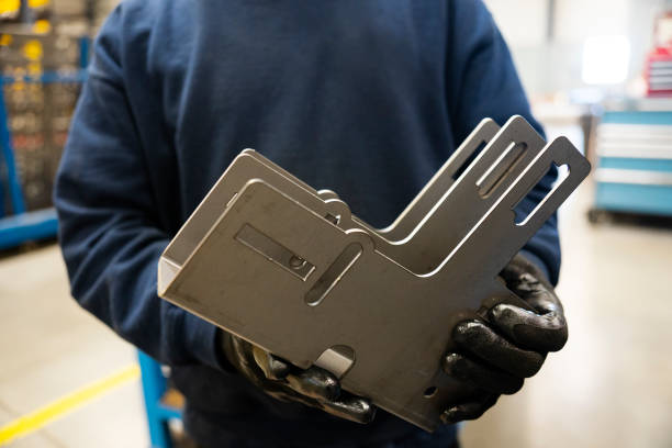 Client reviewing sheet metal part after successful fabrication